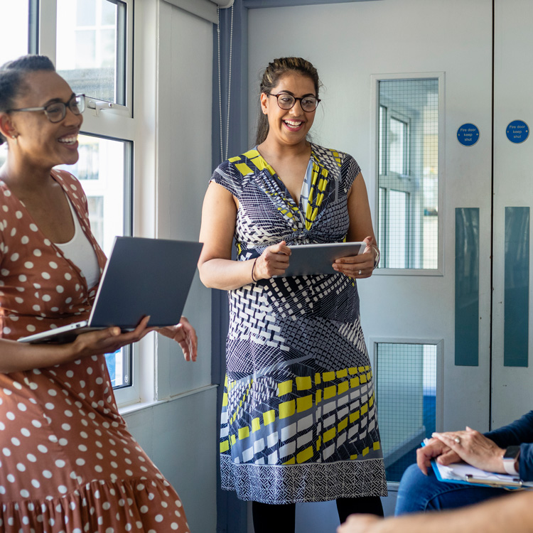 Teachers talking in corridor
