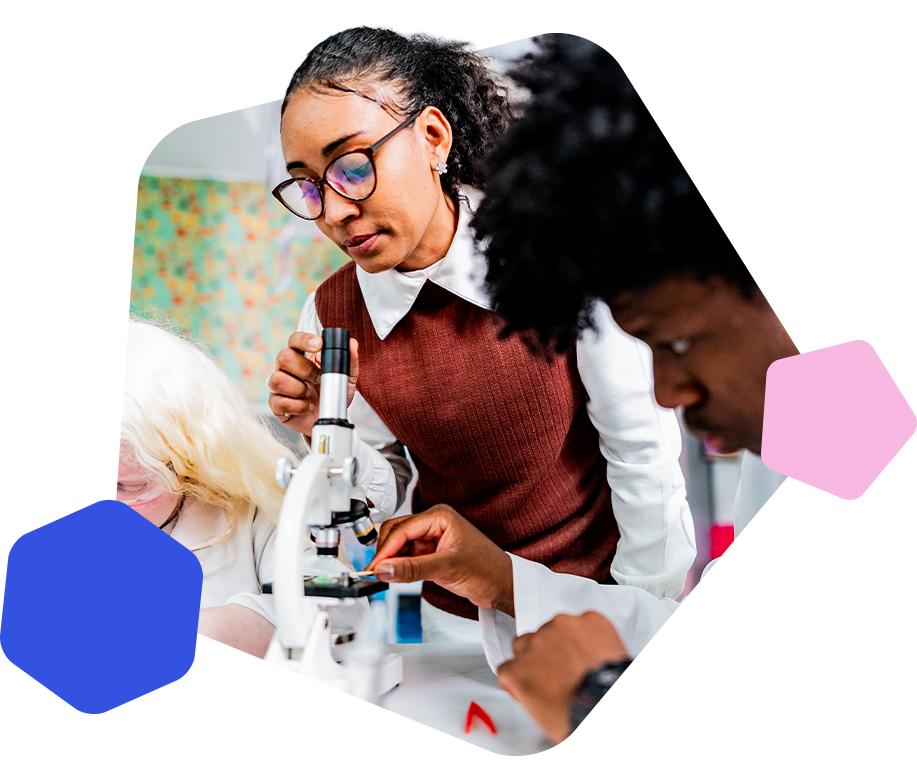 Female science teacher using a microscope