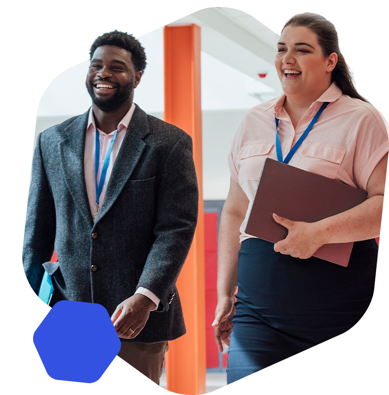 Male and female teacher walking