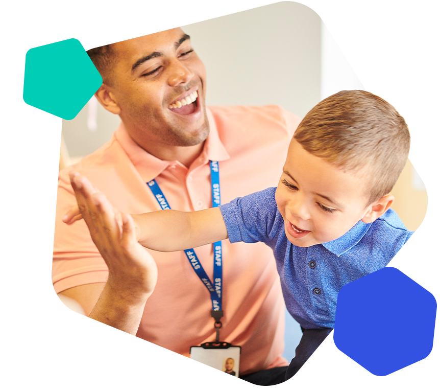 Male early year teacher and boy