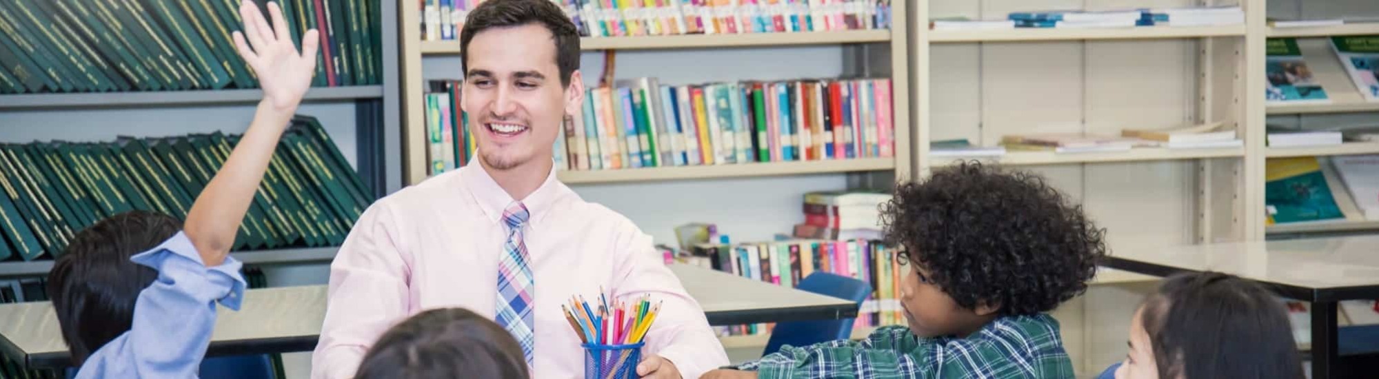 Teacher doing the job of tutoring small group of primary, secondary or special needs children for catch-up and recovery in schools